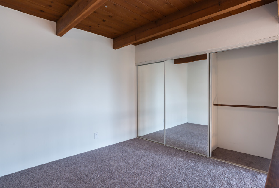 Windward Village Apartments unfurnished bedroom with mirror closet Windward Village Apartments unfurnished bedroom with mirror closet